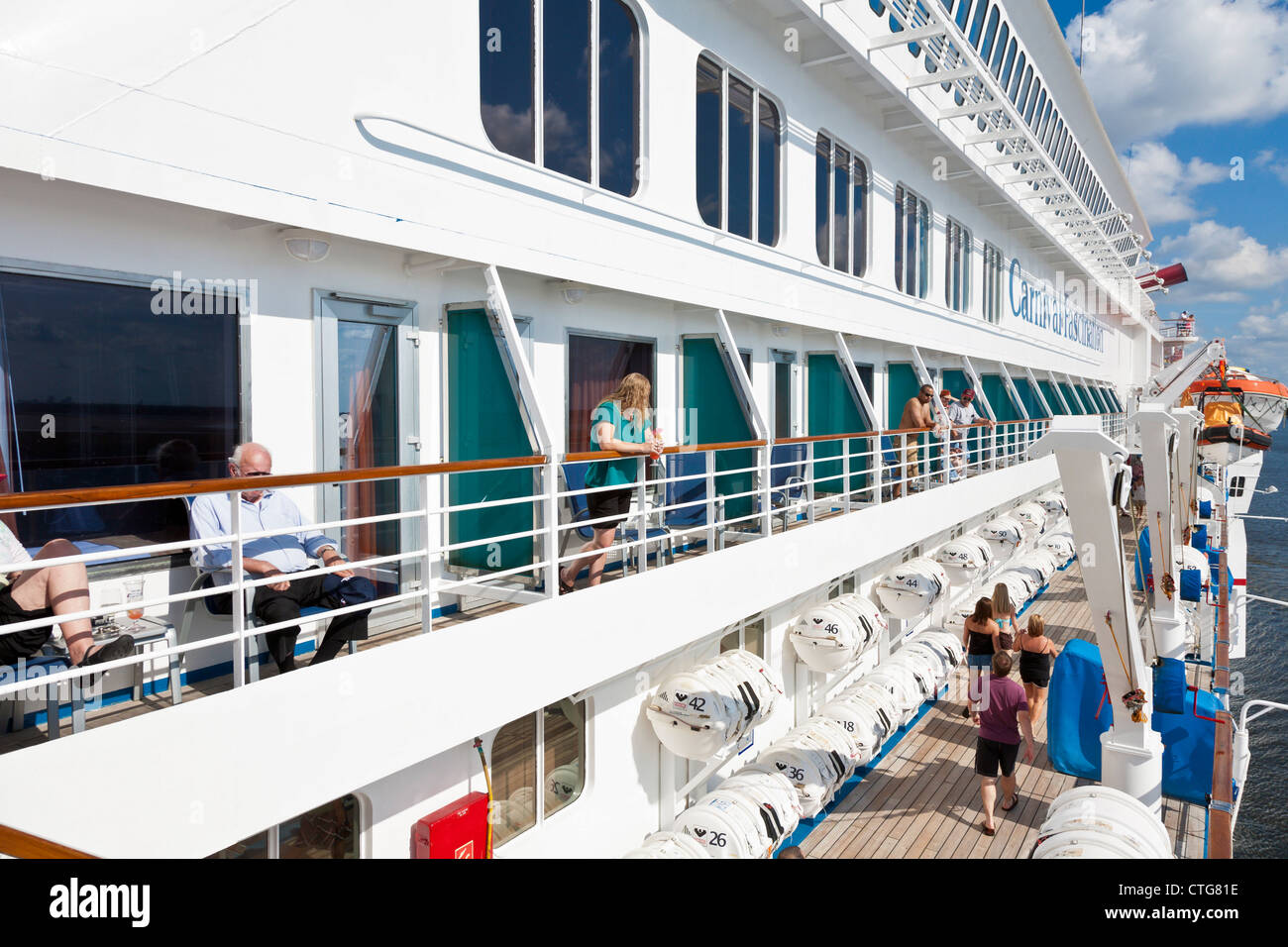 Cruise ship passengers on balconies wait for ship to leave port in Jacksonville, Florida, USA Stock Photo