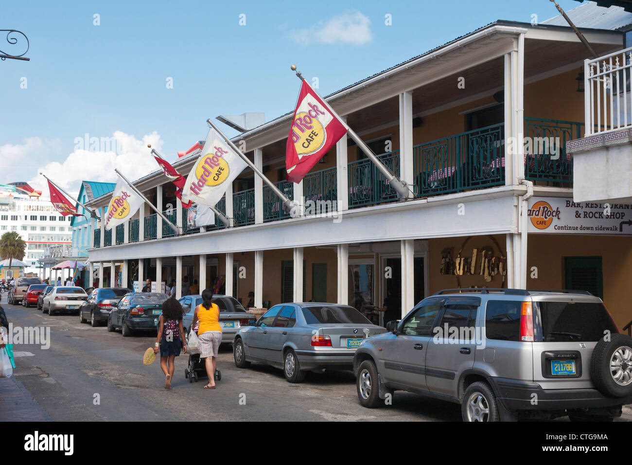 Cars line the narrow streets in front of the Hard Rock Cafe in Nassau, Bahamas Stock Photo