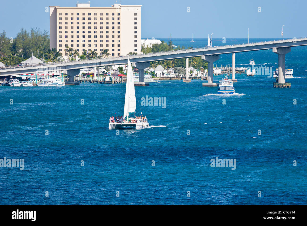 Boat traffic going under the Atlantis Bridge in Nassau, Bahamas Stock