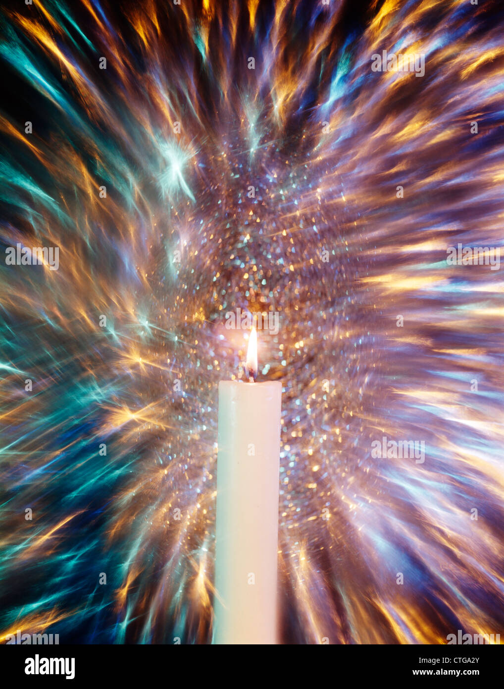 1970s SINGLE WHITE BURNING CANDLE BLURRED ZOOMED STARRY BACKGROUND Stock Photo