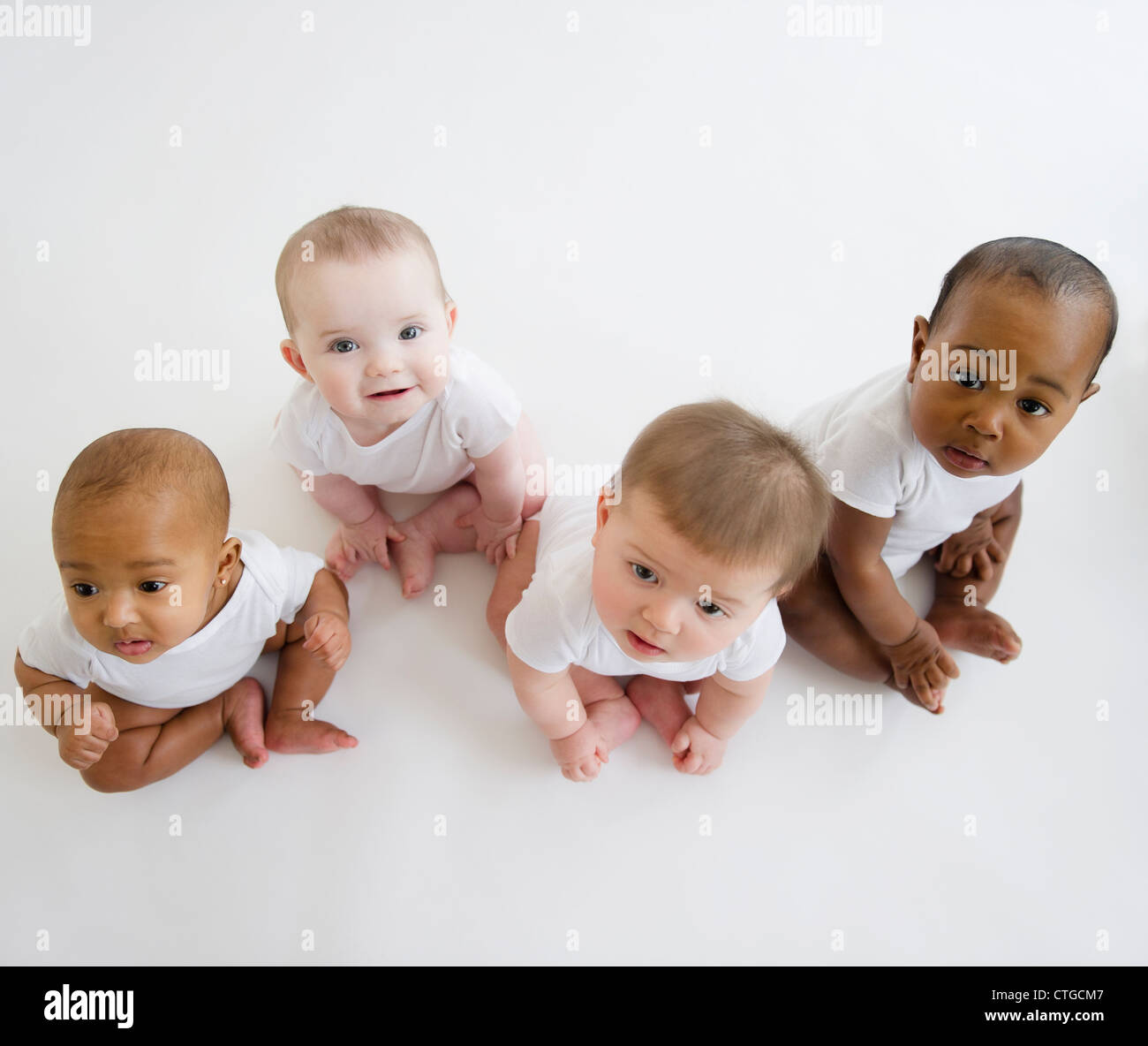 Babies sitting on floor Stock Photo Alamy