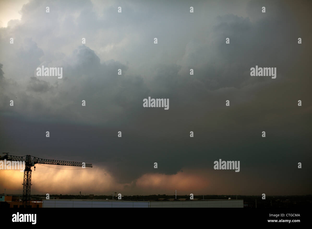 Funnel Cloud Lowering From A Tornadic Thunderstorm Behind A Tower Crane