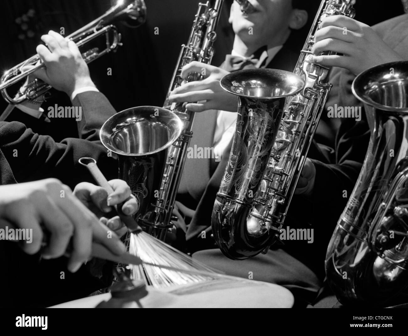 1960s HANDS OF JAZZ COMBO PLAYING SAXOPHONE TRUMPET & CYMBAL WITH WIRE BRUSH DRUMSTICK Stock Photo