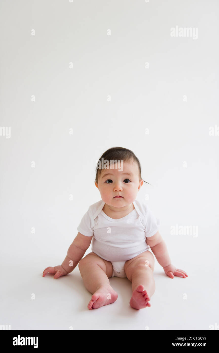 Asian baby girl sitting on floor Stock Photo