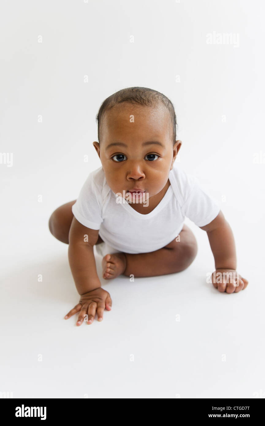 Black baby boy crawling on floor Stock Photo