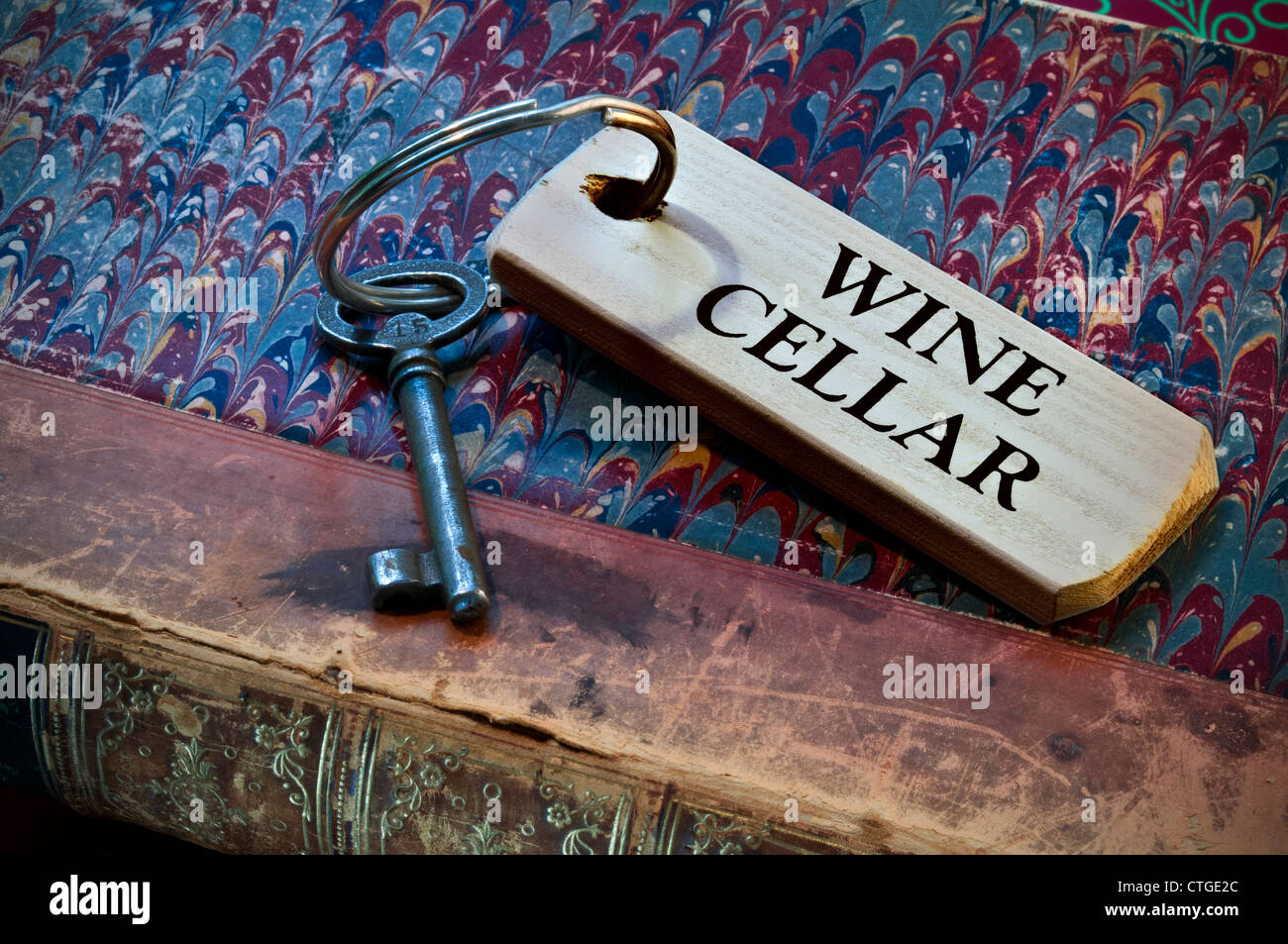 Key to wine cellar on old weathered leather embossed inventory book
