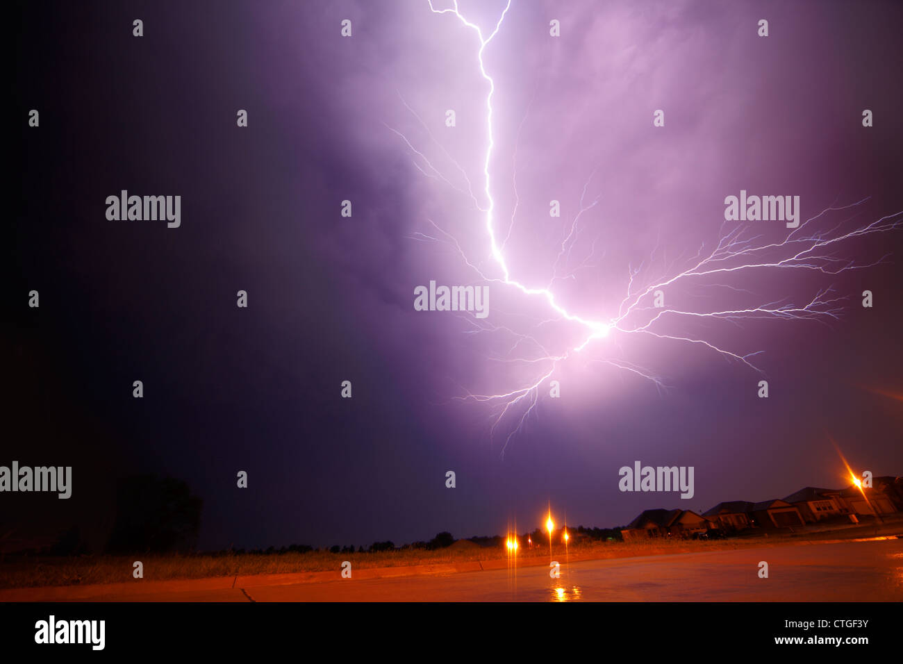 Purple lightning in a night sky. Stock Photo