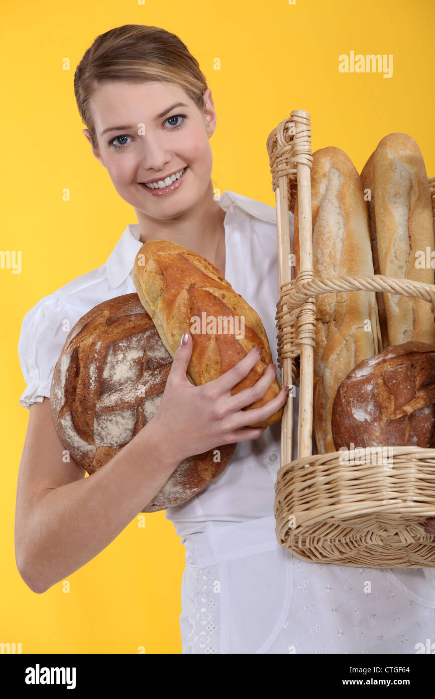 Bakery worker holding basket of bread Stock Photo Alamy