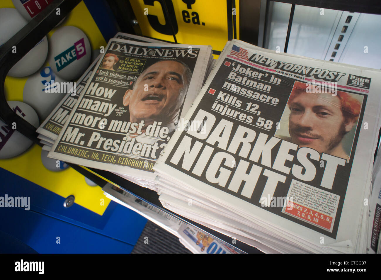 New York daily newspapers report on the mass shooting in a theater in
