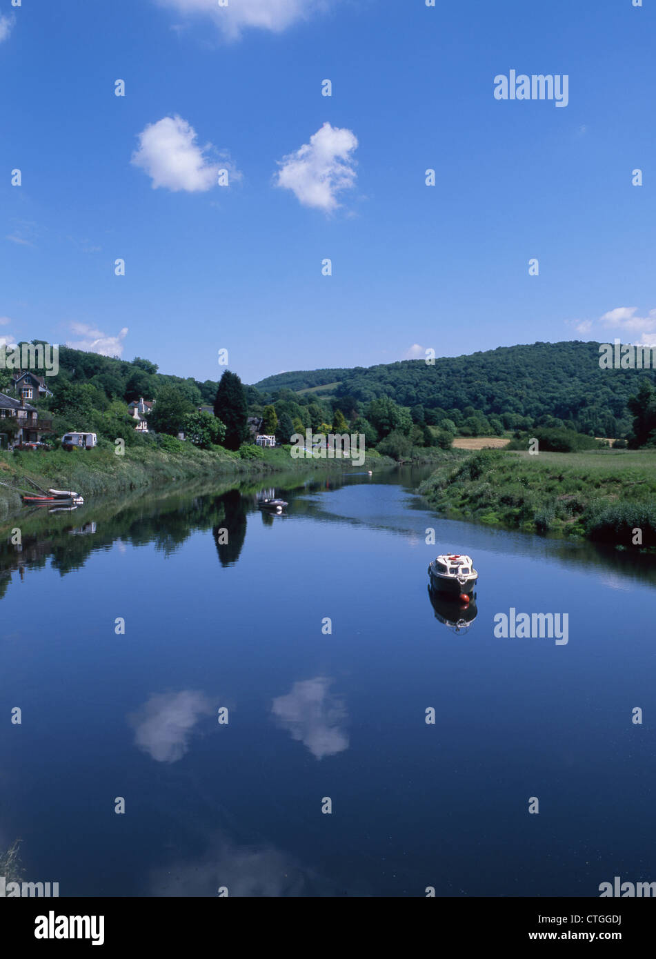 River Wye at Tintern Parva with single boat still waters and reflection
