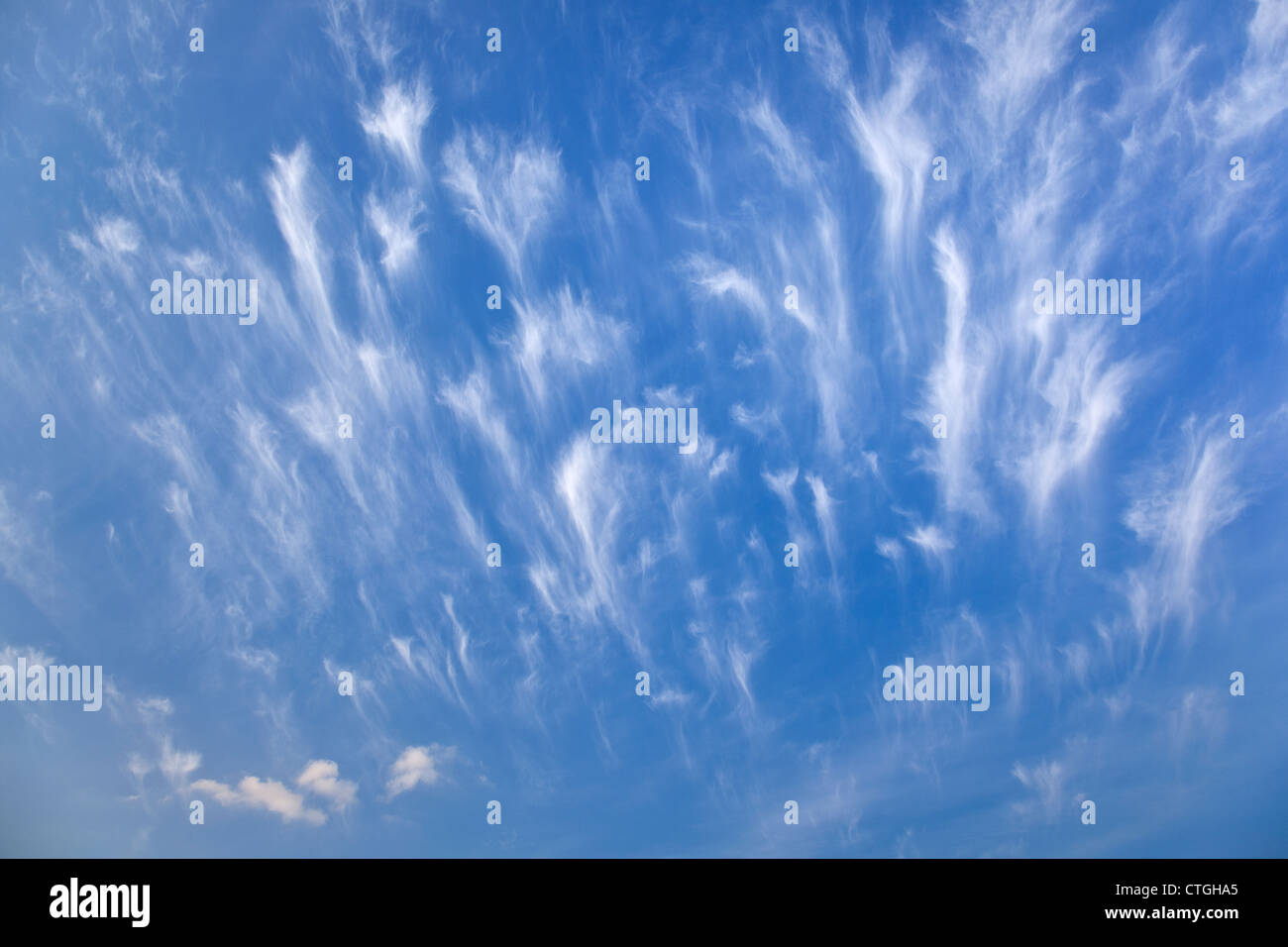 A picture of wispy white clouds under a blue sky Stock Photo - Alamy