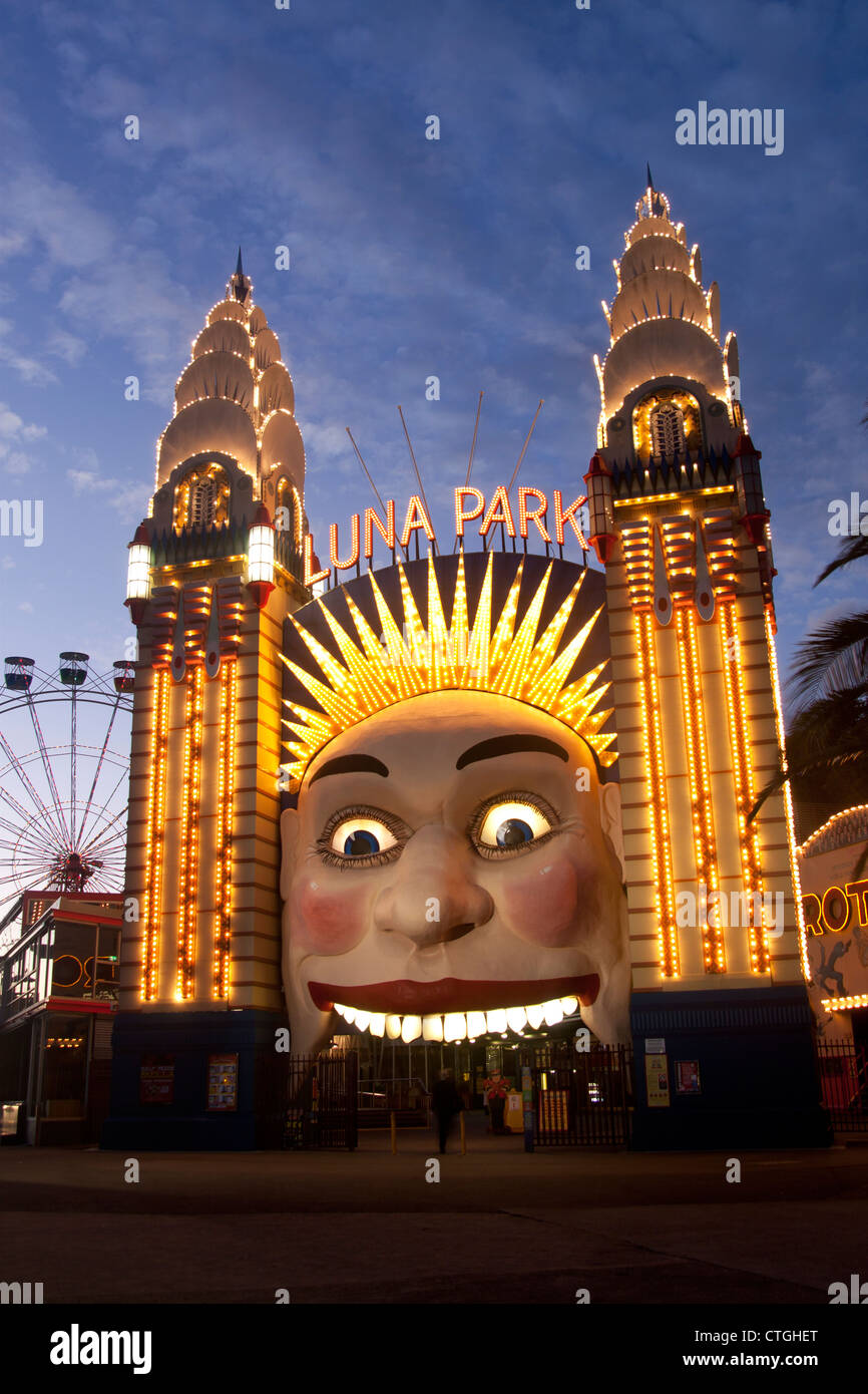 The entrance to Luna Park funfair at night, with the grinning face and ferris wheel Milsons Point Sydney NSW Australia Stock Photo