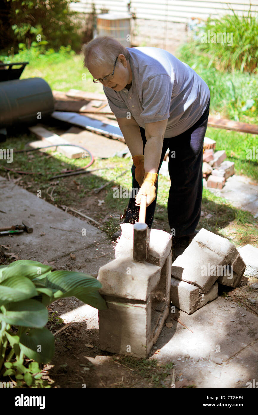 Woman Breaking Concrete Block With Sledgehammer Stock Photo Alamy