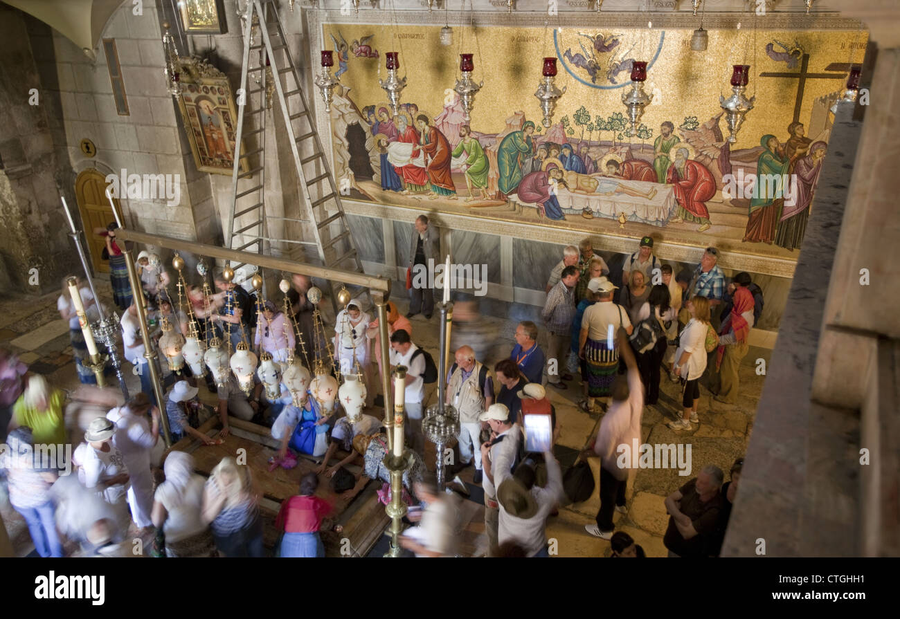 Mural depicting the death of Jesus Christ and the Stone of Anointing in the Church of the Holy Sepulchre, Jerusalem, Israel Stock Photo