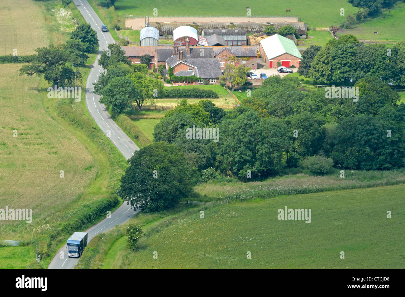 Aerial view of agriculture from above looking down on farm buildings & farmhouse with adjacent countryside farmland on the fertile Cheshire Plains UK Stock Photo