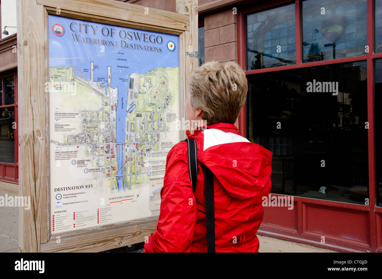 New York, Oswego. Tourist looking at Oswego city map in downtown. Stock Photo