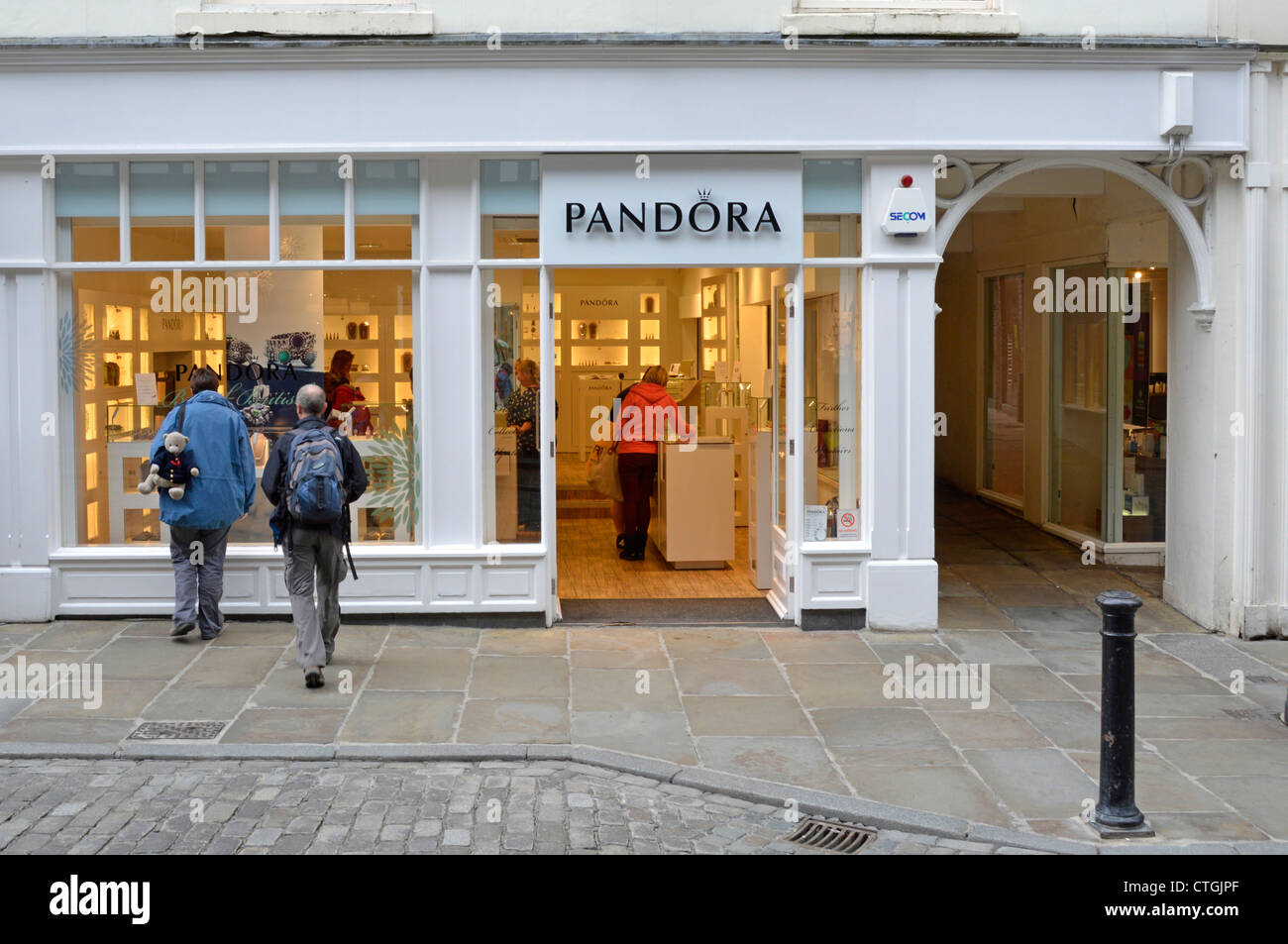 Window shopping & shoppers inside a Pandora shop which sells customizable jewellery City of Chester Cheshire England UK Stock Photo