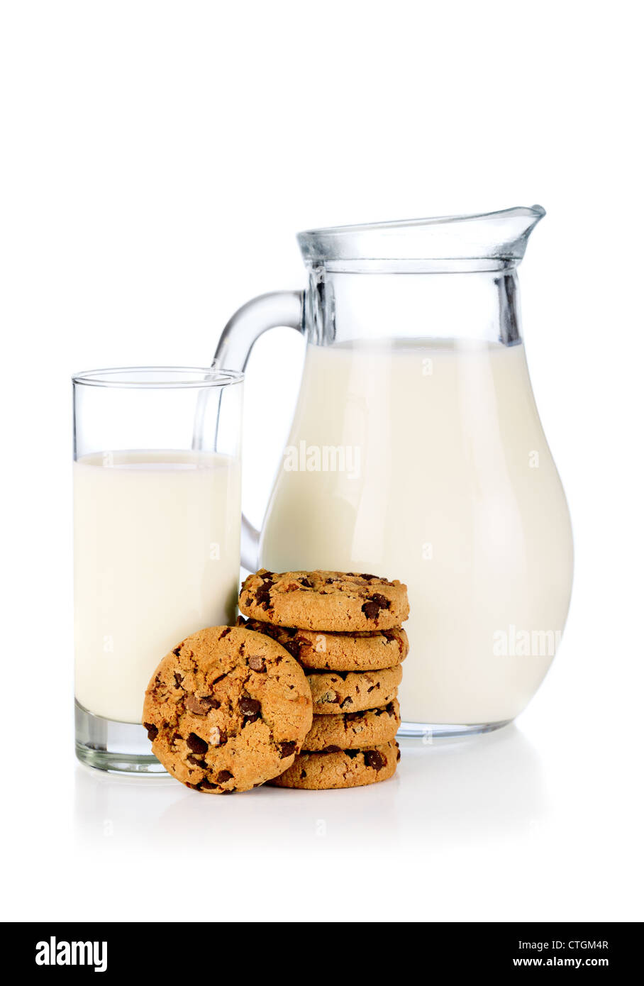 Glass, pitcher of milk and cookies Stock Photo