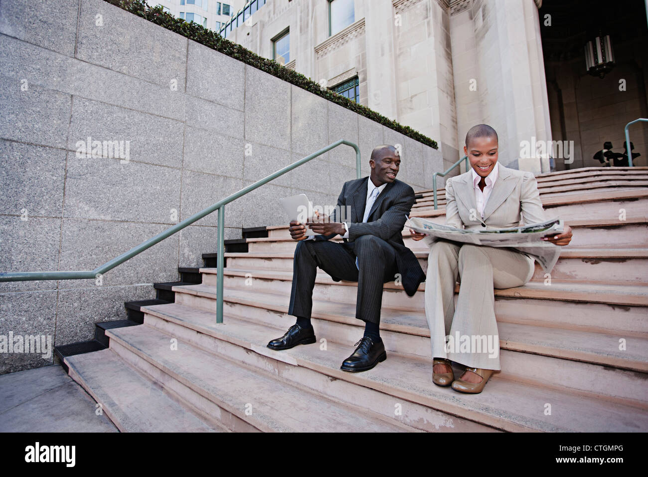 Two people sitting on stairs hi-res stock photography and images - Alamy