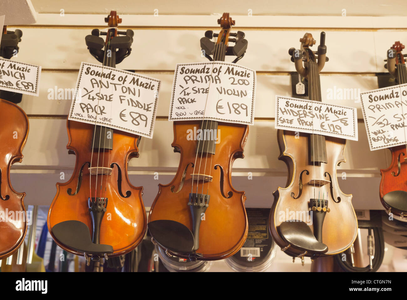 Kenmare, County Kerry, Ireland. Violins for sale in music shop. Stock Photo