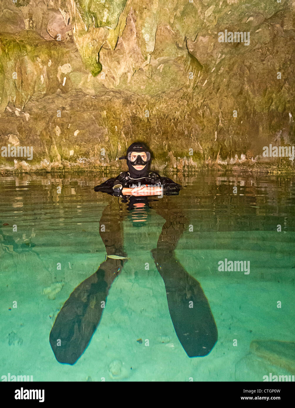 Scuba diver prepares to enter DreamGate, one of the many cenotes where people can scuba dive in Akumal, Yucatan, Mexico. Stock Photo