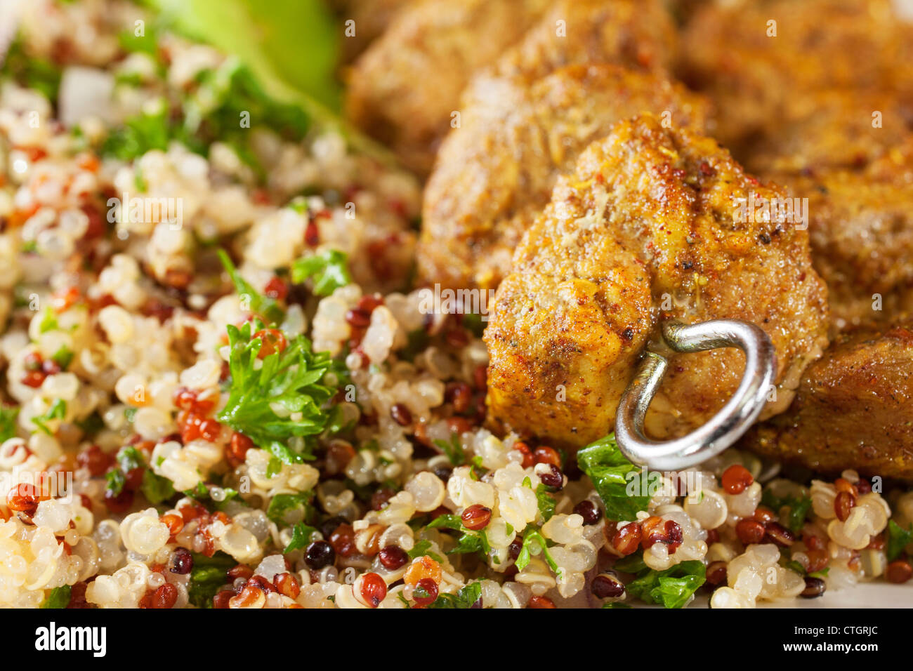Spicy kebab with quinoa salad. Contains red, black and white quinoa, also amaranth. Shallow DOF. Stock Photo