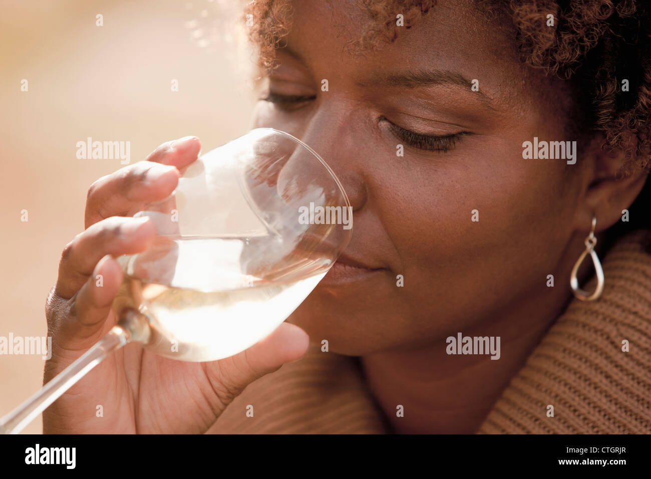 Black woman drinking wine Stock Photo