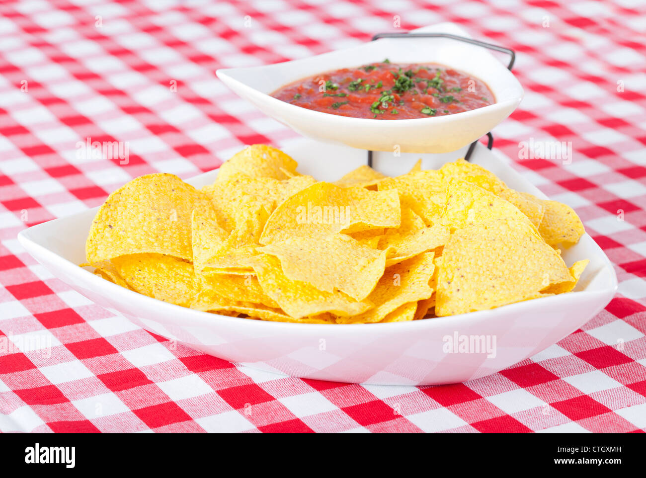 Chips and salsa on checkered tablecloth Stock Photo Alamy