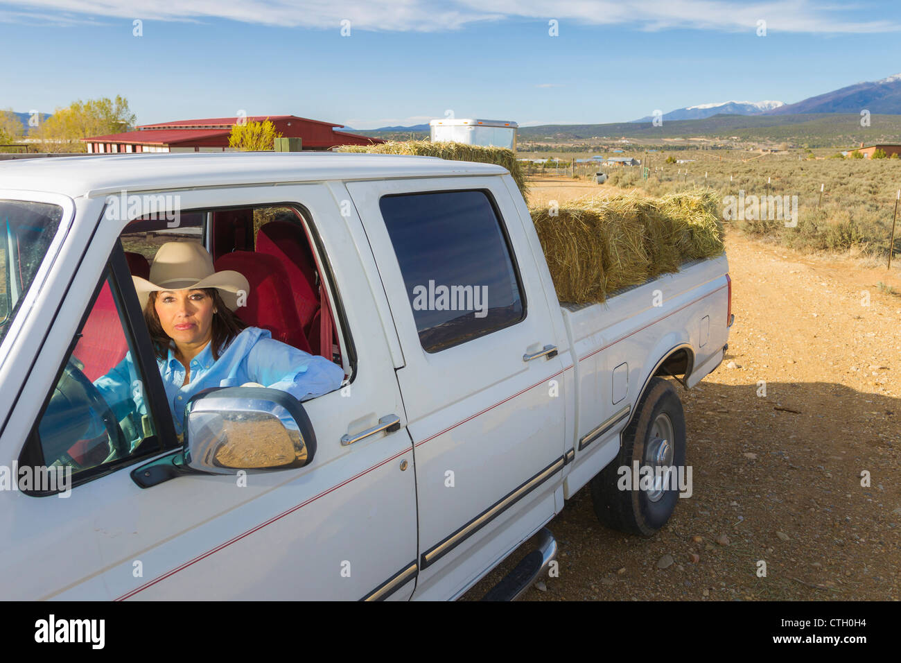 Hispanic woman driving truck Stock Photo