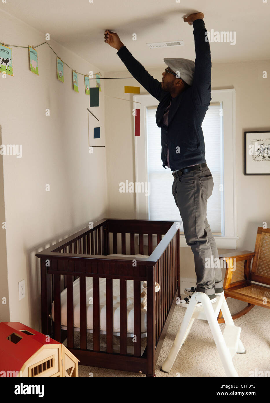 Black man decorating bedroom Stock Photo - Alamy