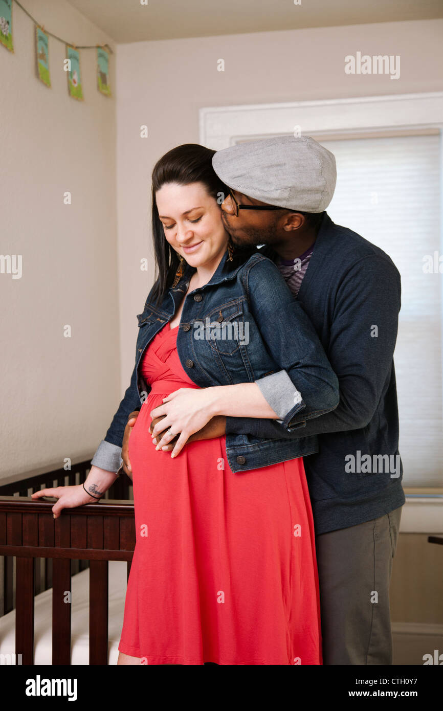 Man hugging pregnant wife Stock Photo - Alamy