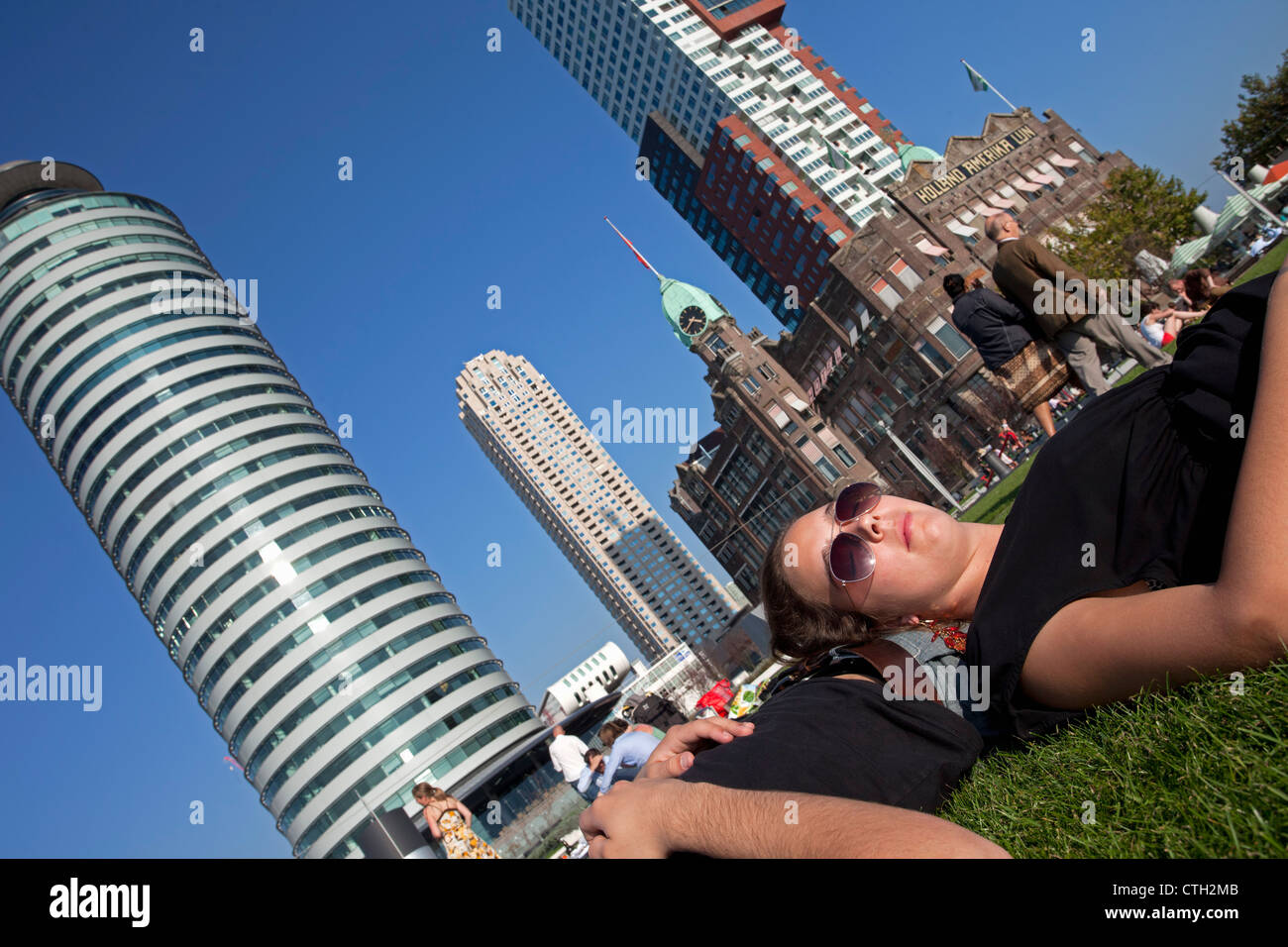 People relaxing on former quay of cruise ship company Holland America Line. now continues as Hotel New York. Stock Photo