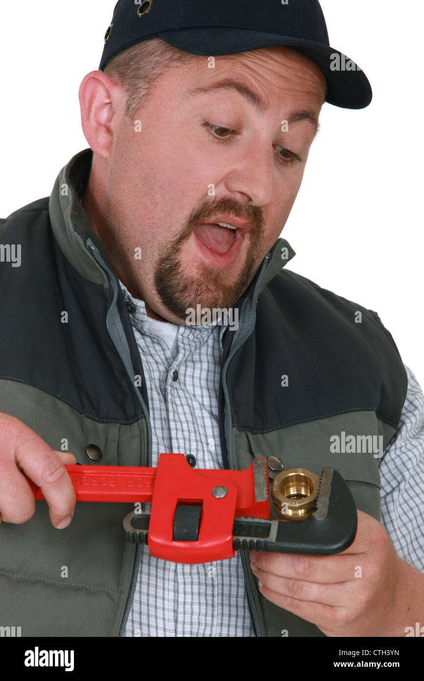Plumber tightening nut with adjustable wrench Stock Photo