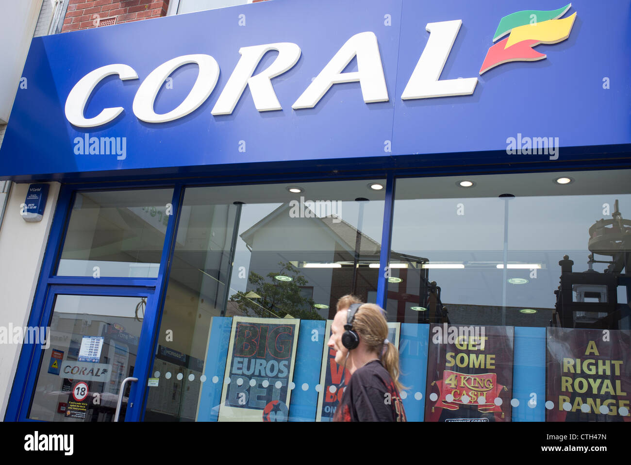 man walking past a Coral bookmakers shop Stock Photo - Alamy