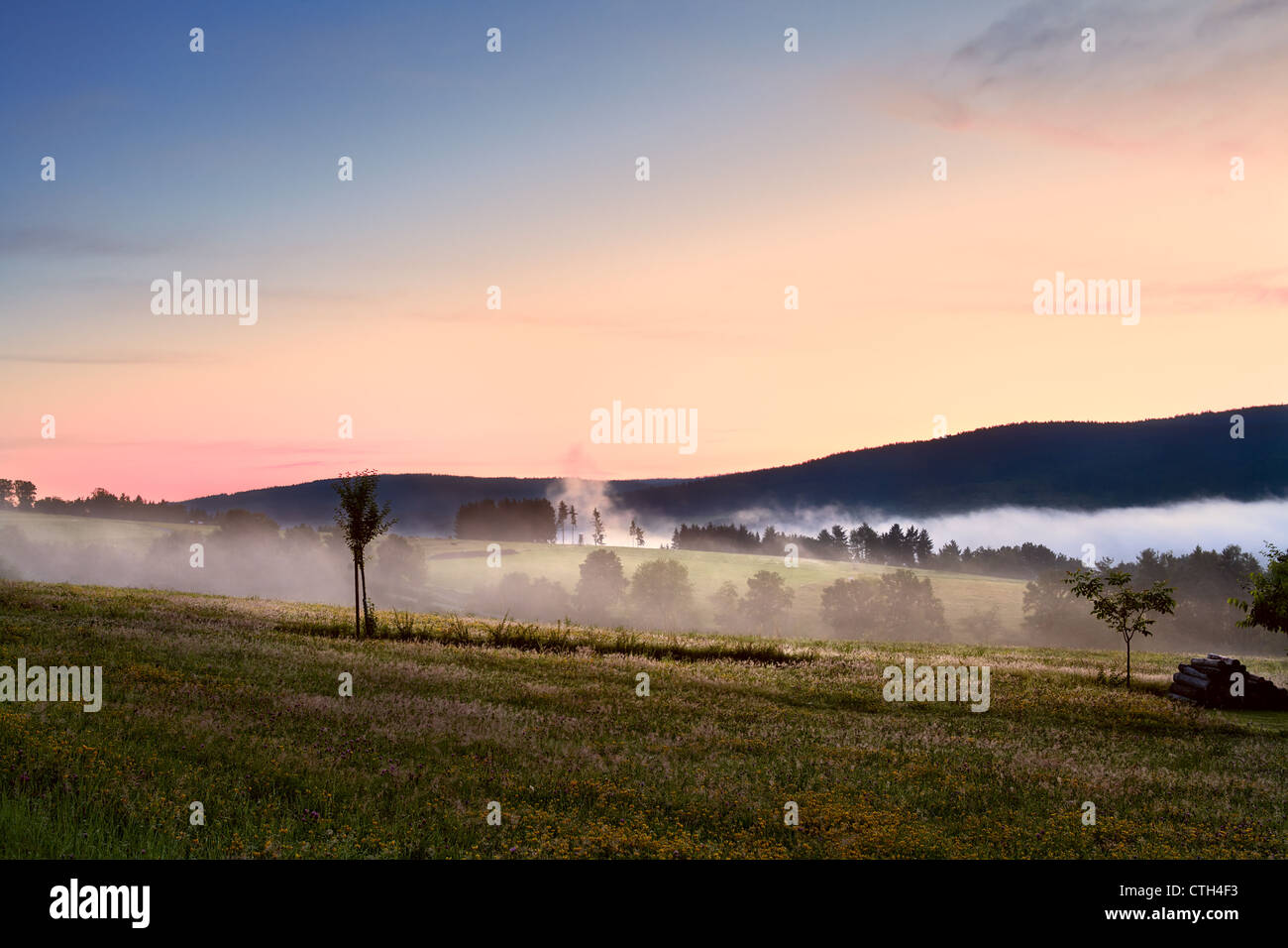 fog in mountains during colorful sunrise Stock Photo
