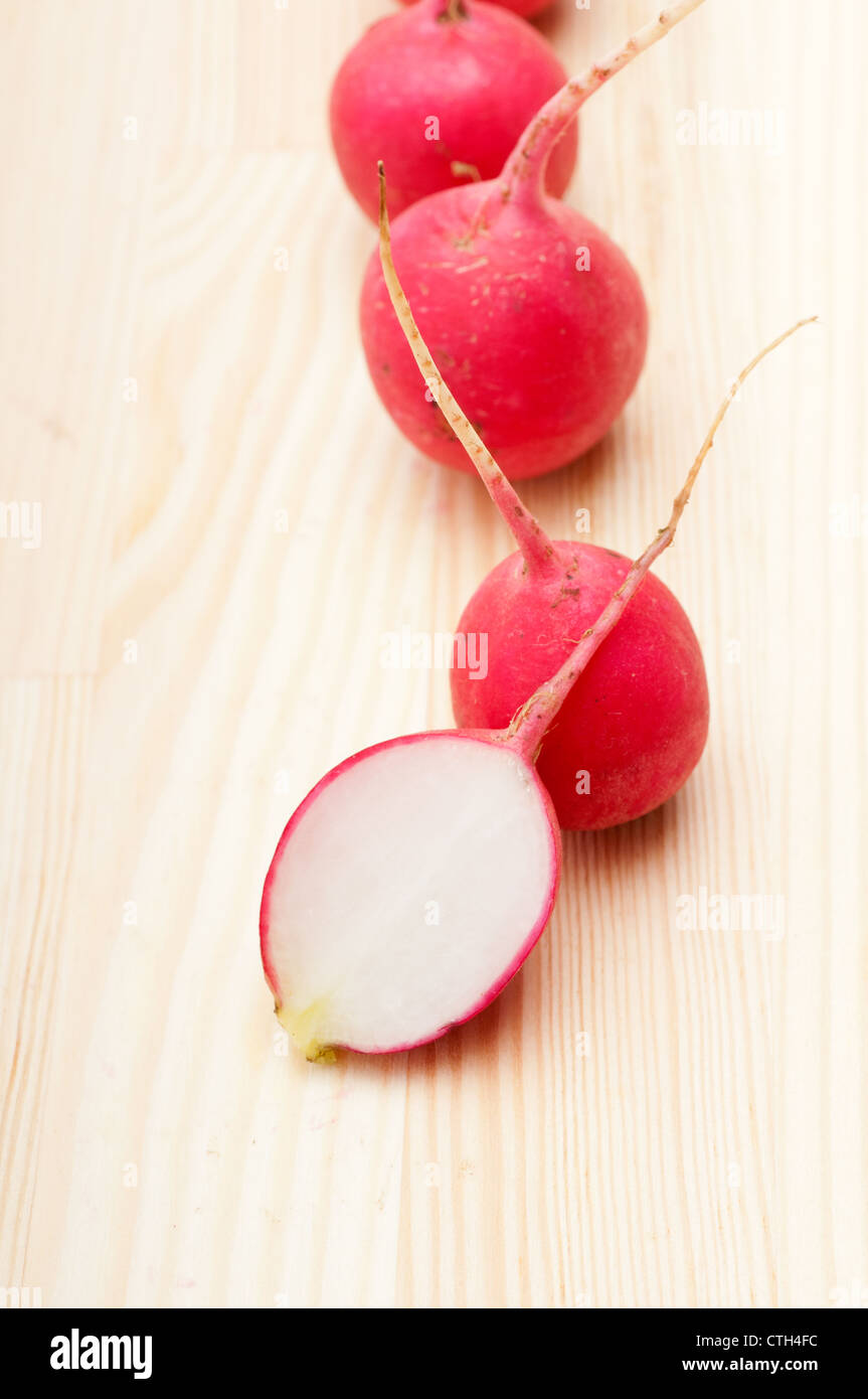 fresh red raw raddish over pine wood table closeup Stock Photo - Alamy