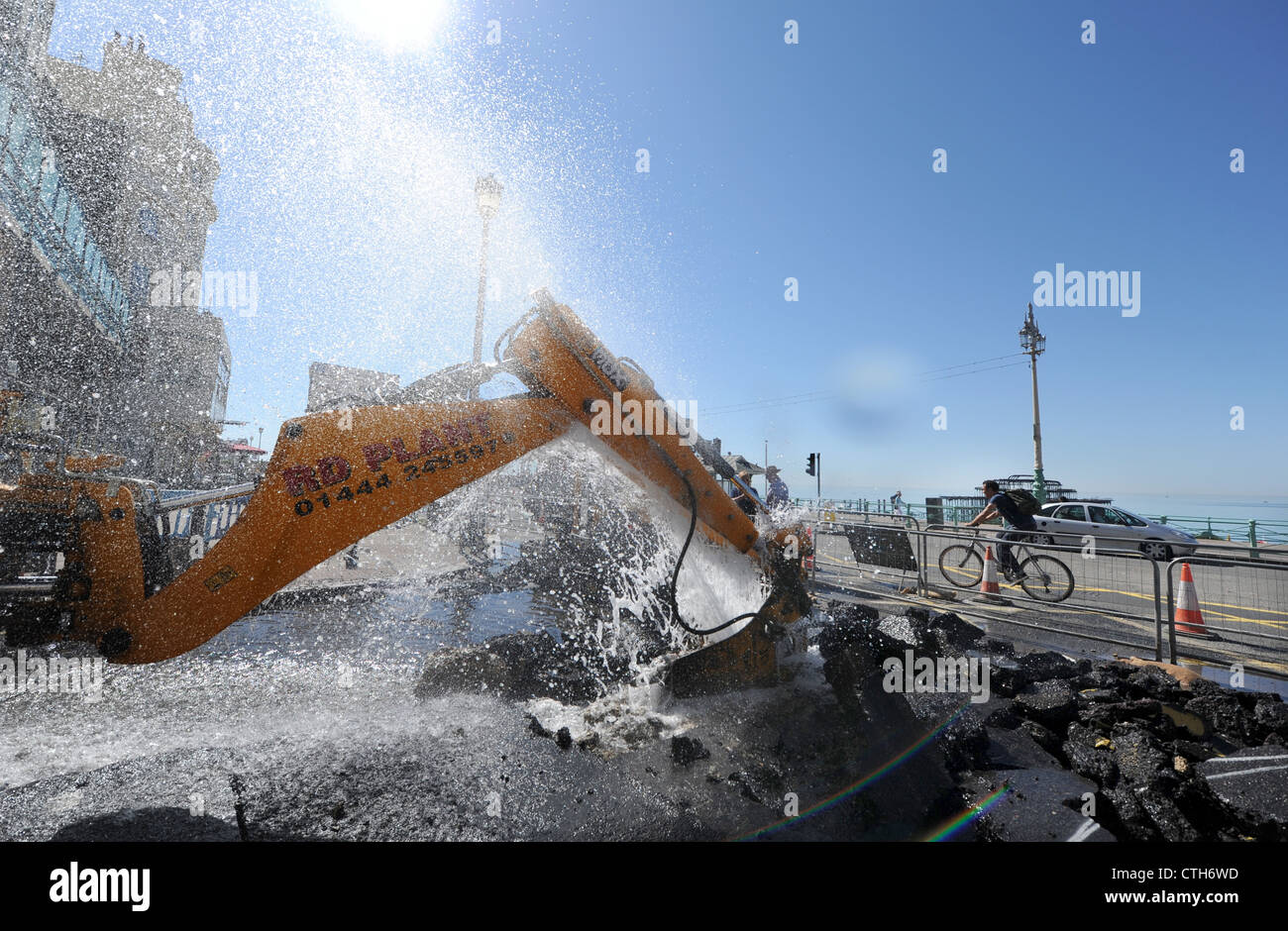 Water spouts out of the road at the bottom of Preston Street in Brighton after a JCB digger went through a mains pipe Stock Photo