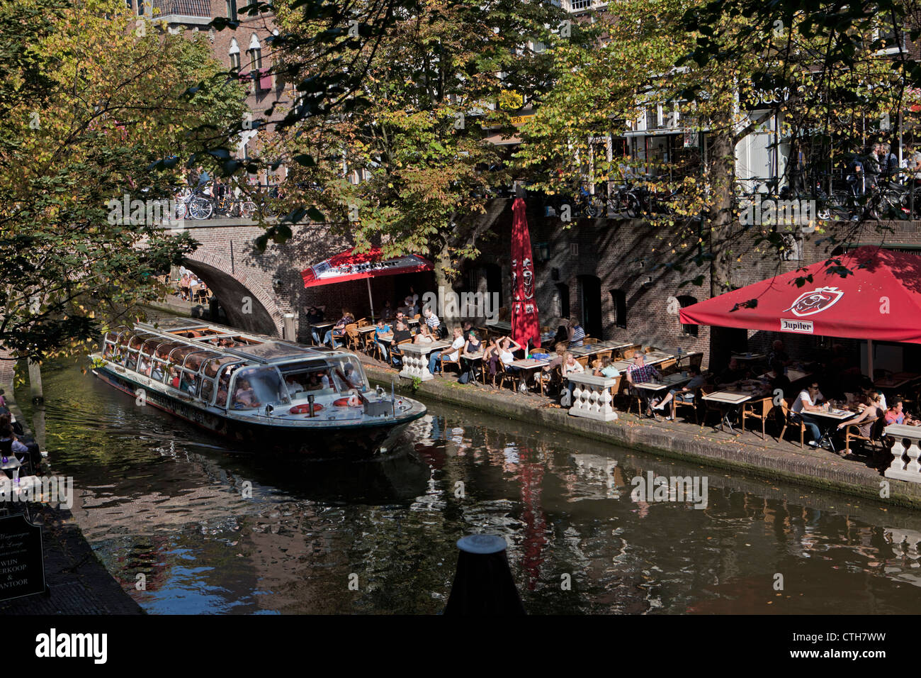 The Netherlands, Utrecht, Outdoor cafes at canal called Oude Gracht. Tour boat. Stock Photo