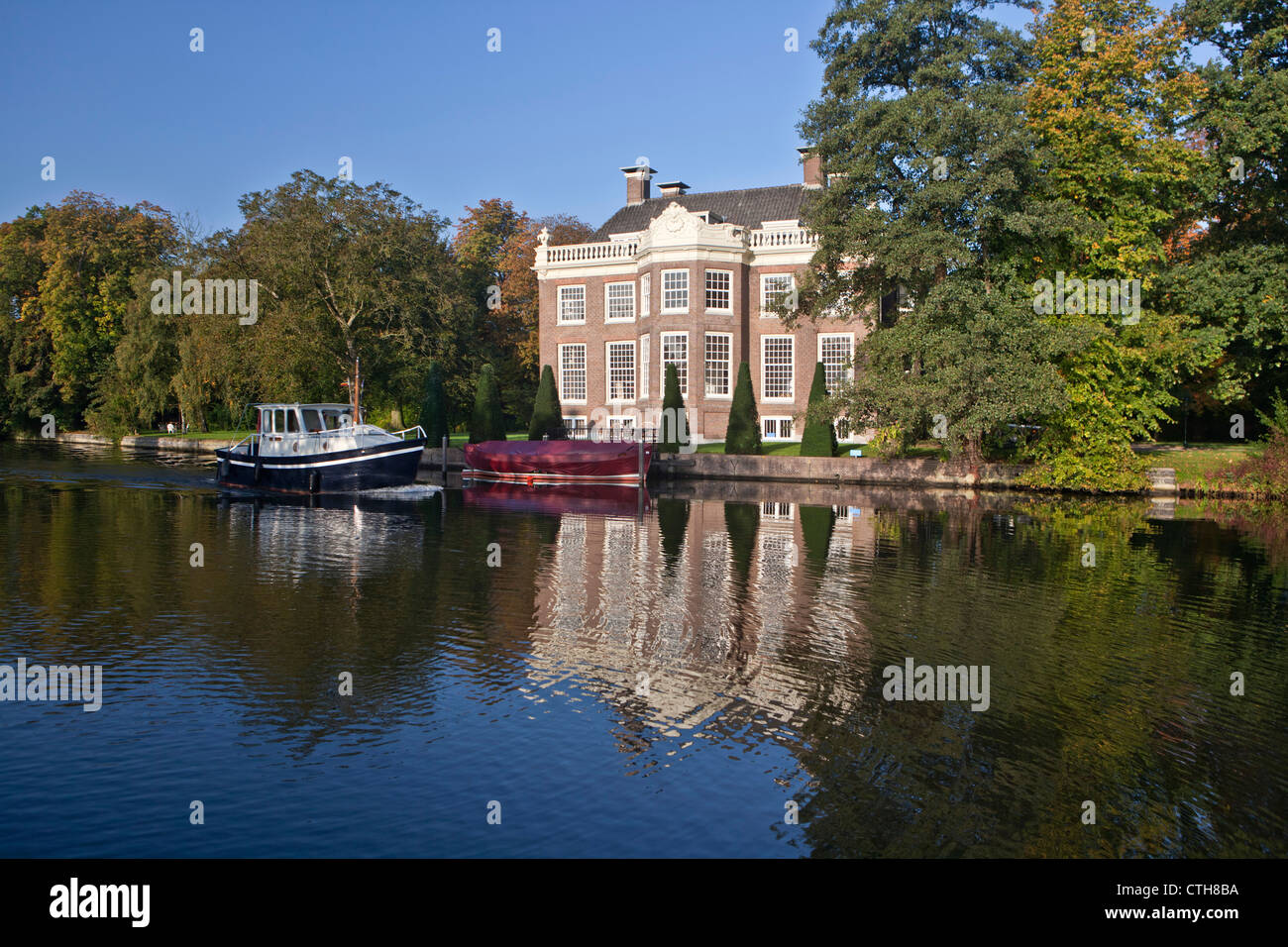 The Netherlands, Breukelen, Pleasure boat on the river Vecht. Rural estate called Rupelmonde. Stock Photo