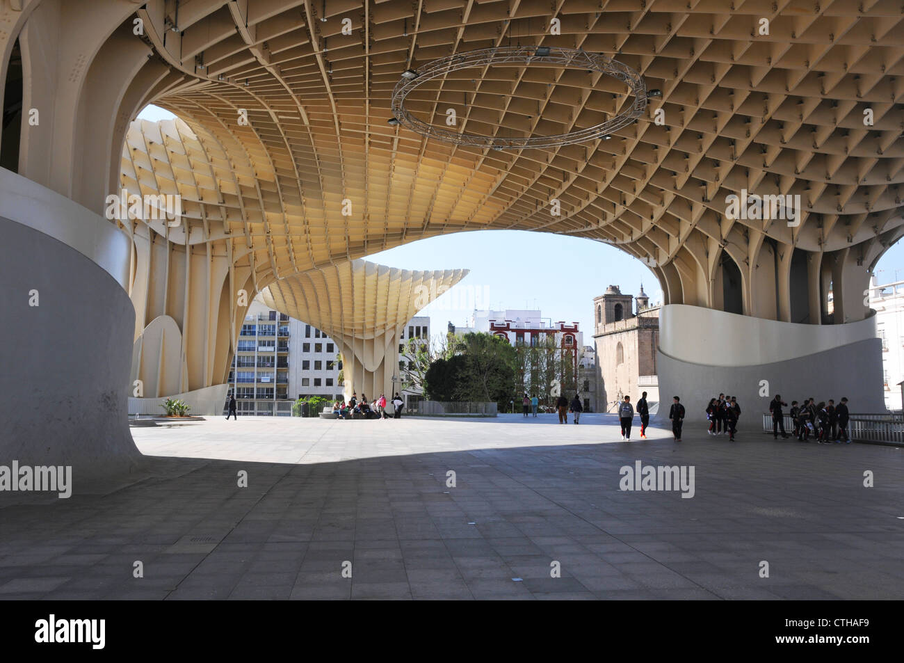 People under modern architectural roof structure in Plaza de la Encarnacion, Seville, Spain. Stock Photo