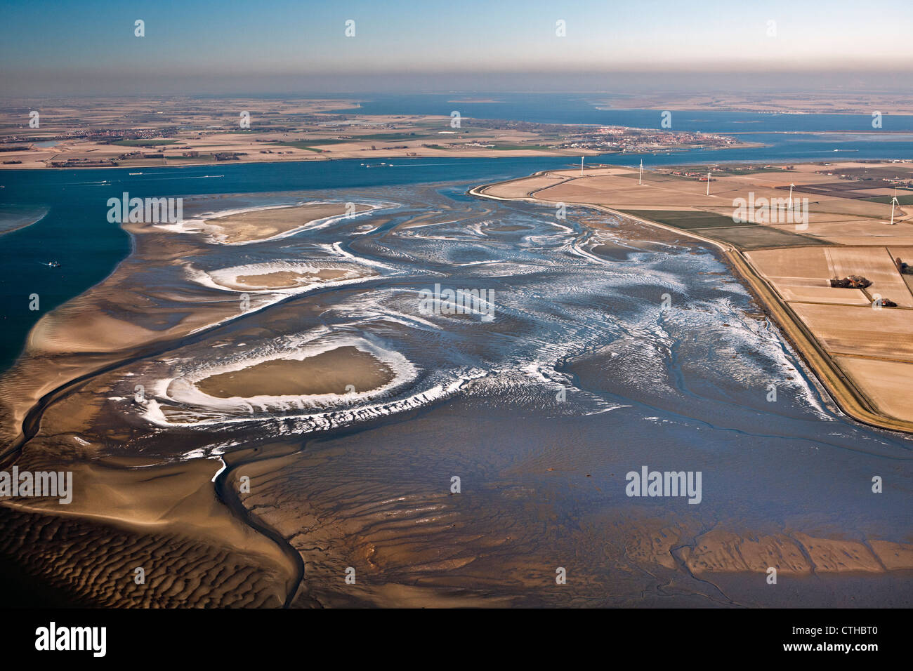 The Netherlands, St Philipsland, Frozen brackish water at low tide. Aerial. Stock Photo