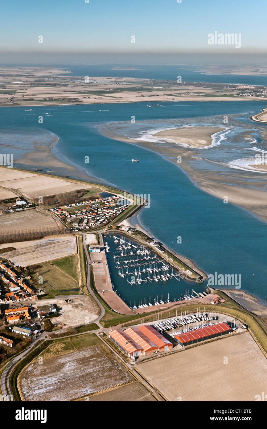 The Netherlands, Sint Annaland, Frozen brackish water at low tide. marina. Aerial. Stock Photo