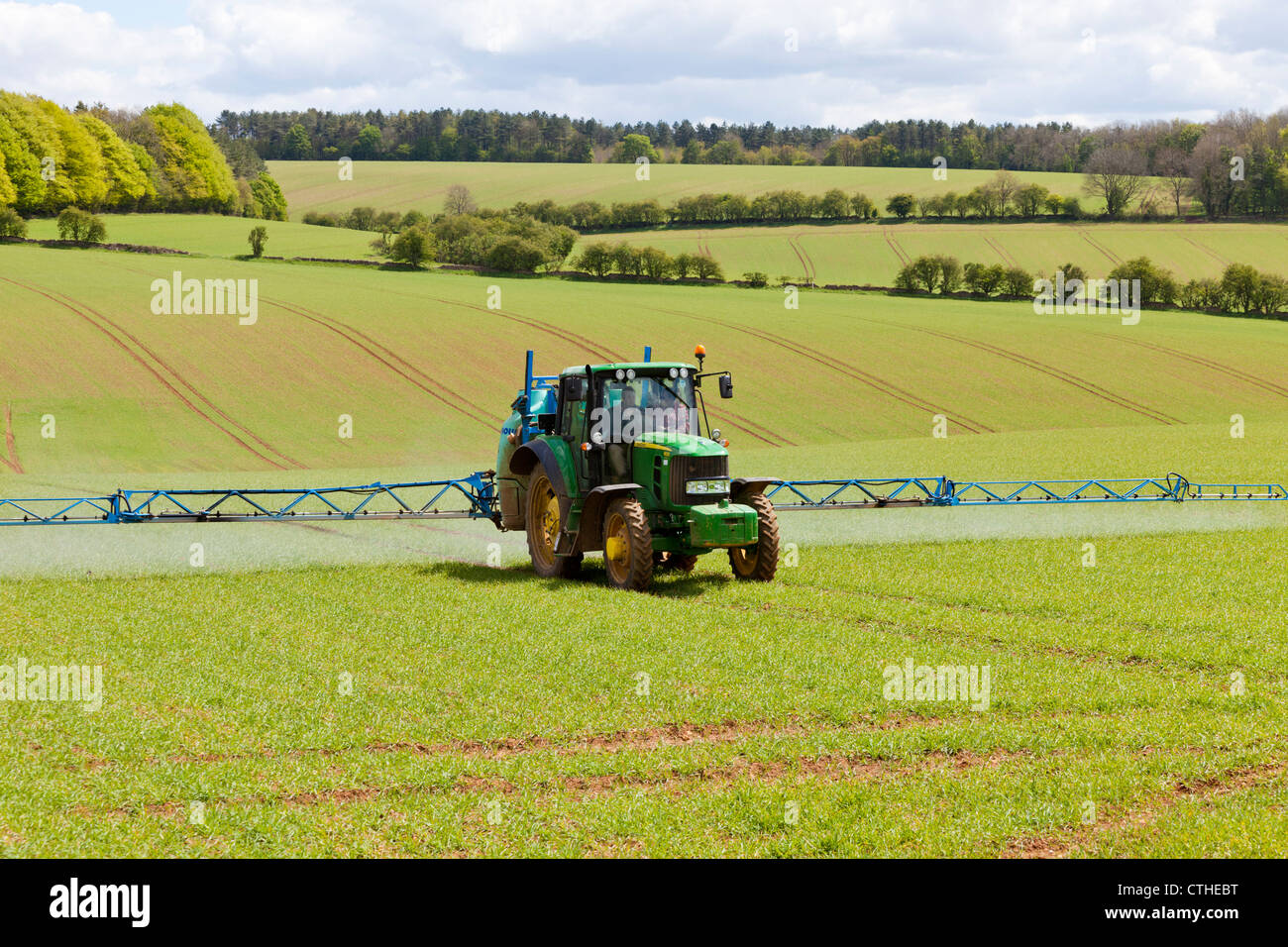 Crop spraying on the Cotswolds near Snowshill, Gloucestershire Stock Photo