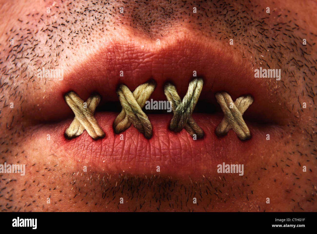 Close up of man's mouth with lips stitched or sewn shut. Stock Photo