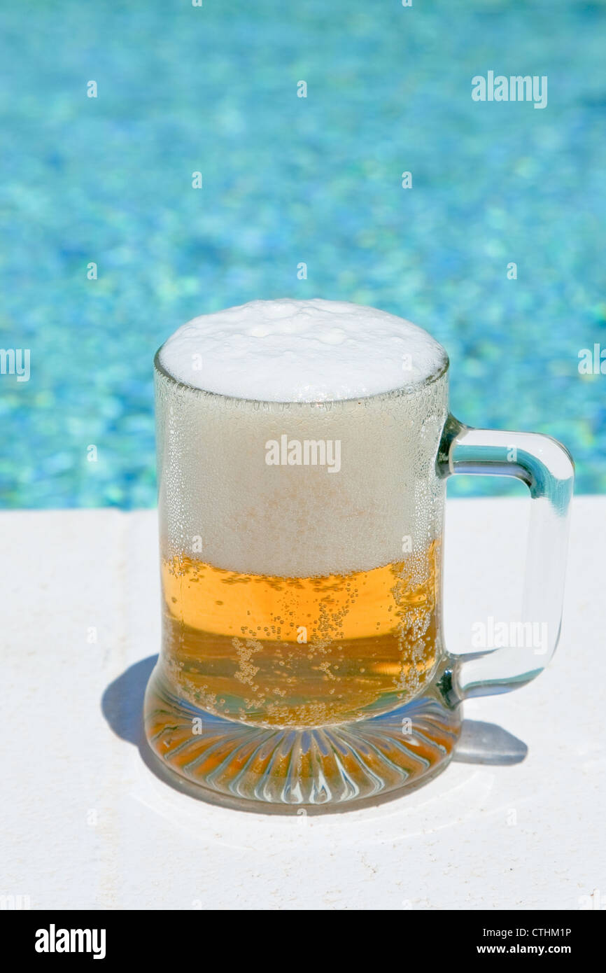glass of cold beer on pool board in hot summer day Stock Photo