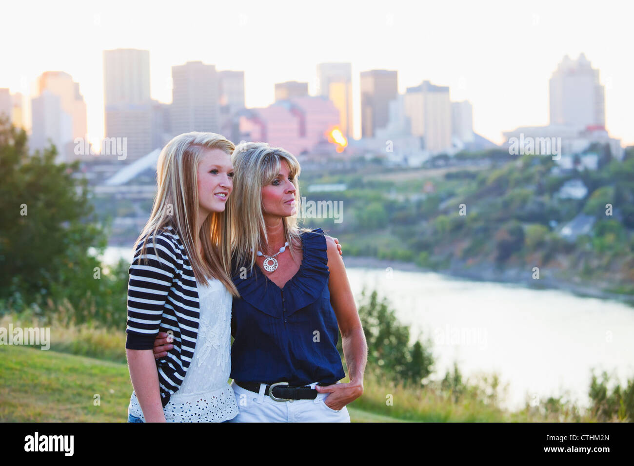 Mother And Daughter In A Park Together With The City Skyline In The Background; Edmonton, Alberta, Canada Stock Photo