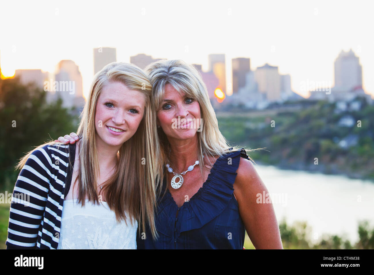 Mother And Daughter In A Park Together With The City Skyline In The Background; Edmonton, Alberta, Canada Stock Photo