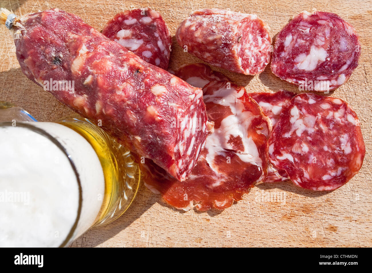 italian salami and glass of beer on wooden board Stock Photo