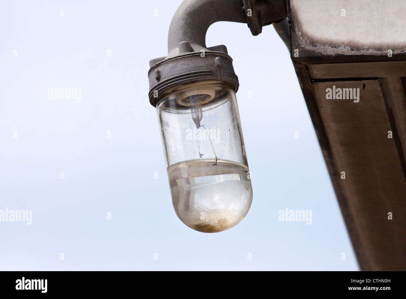 Outdoor light fixture with broken bulb, filled with water Stock Photo -  Alamy