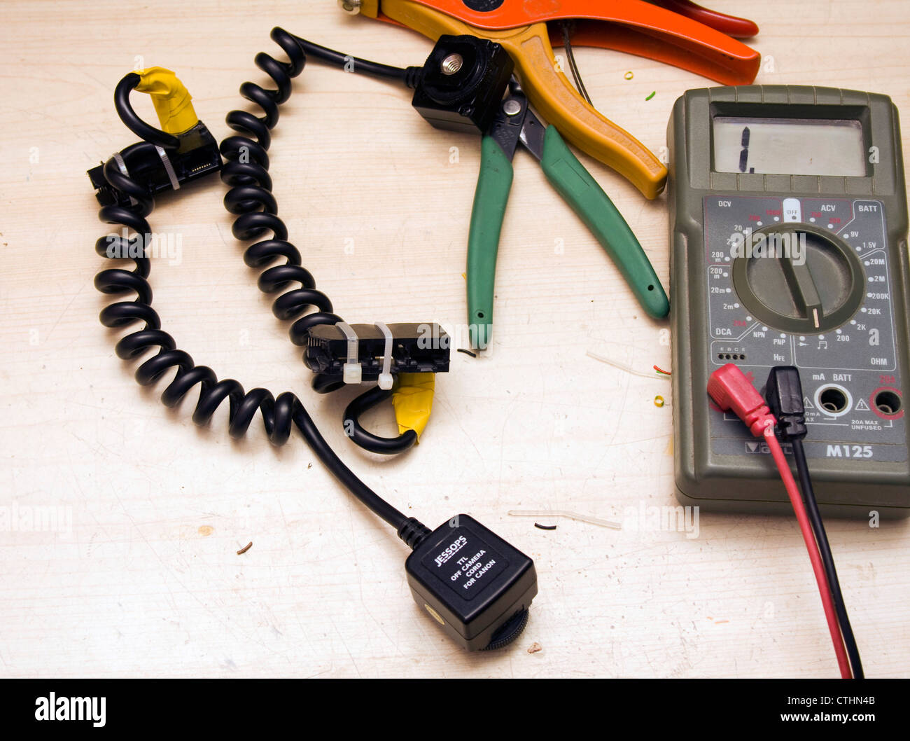 Electrical tools, a multimeter and a curly cable on a work bench Stock ...